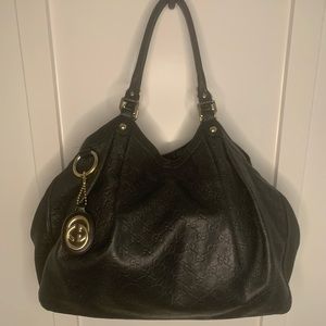 Large Authentic Gucci Gg embossed black guccissima leather Sukey tote.